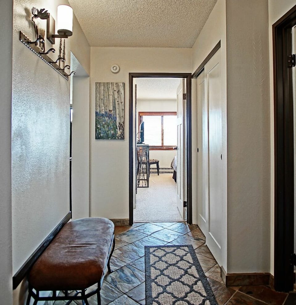 Entry with bench, coat hooks, and closet