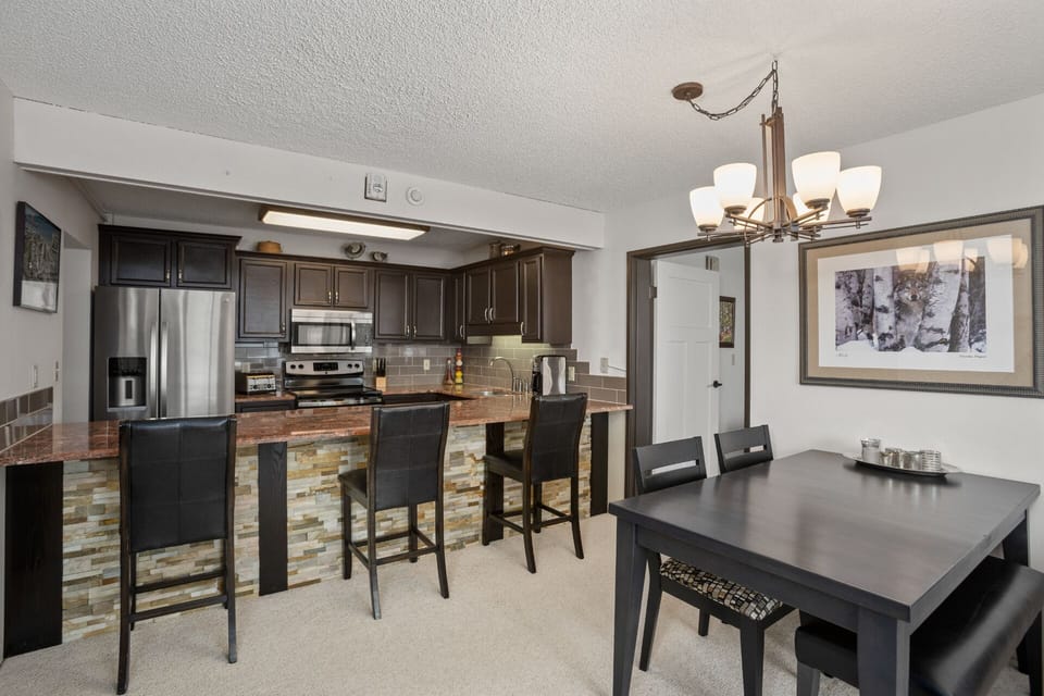 Open Concept Space - Dining Table & Bar Seating at Kitchen Island