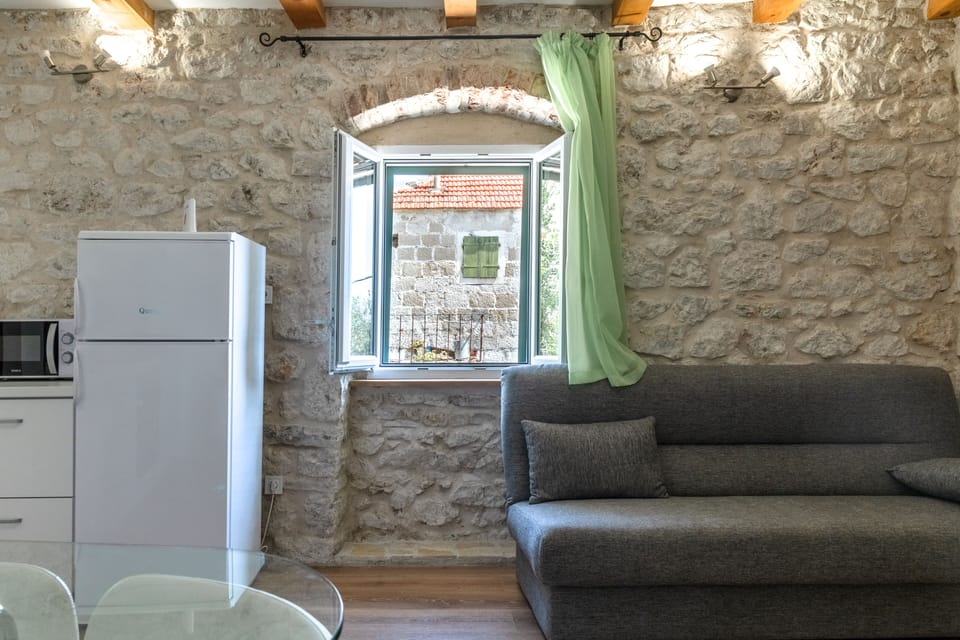 A living room with smart TV, A/C, pull-out sofa and panoramic sea views
