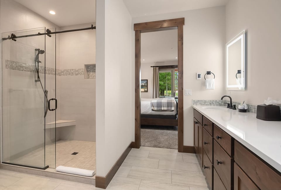 Larkspur Woods: - Main floor King Suite private bath with a large tile shower.