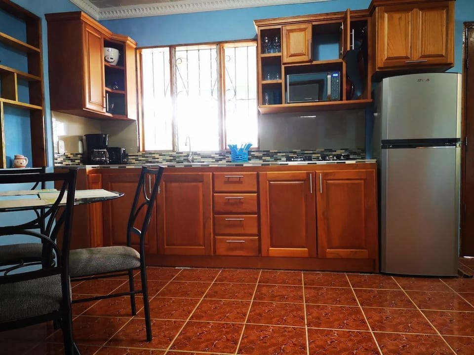 Wooden cabinetry and essential appliances make this kitchen fully functional