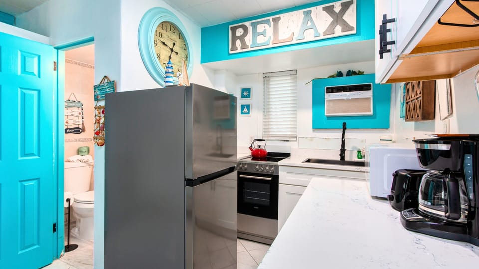 Cool tile floors, ceiling fan, and powerful wall-unit A/C keep the space refreshing after a day in the sun