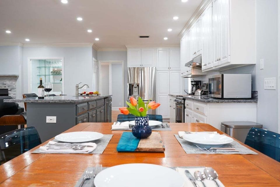 Kitchen island with tulips and open dining area behind