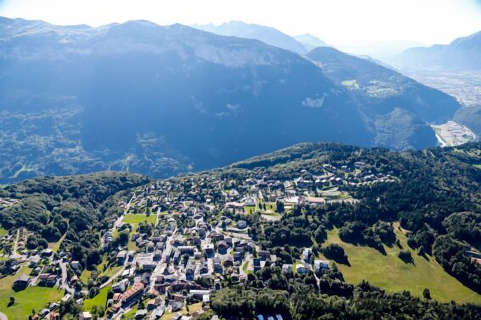 Hot air balloon view of Les Carroz, the Aravis on the opposite side of the valley, and in the distance Cluses in the valley.