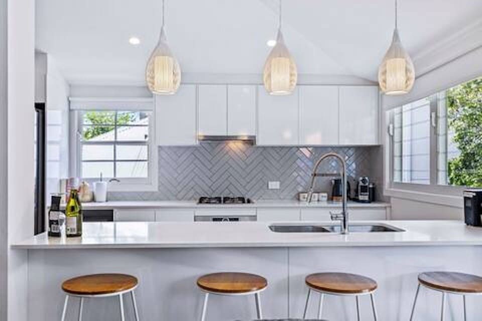 Gas cooking, full-size appliances and island seating in the kitchen.