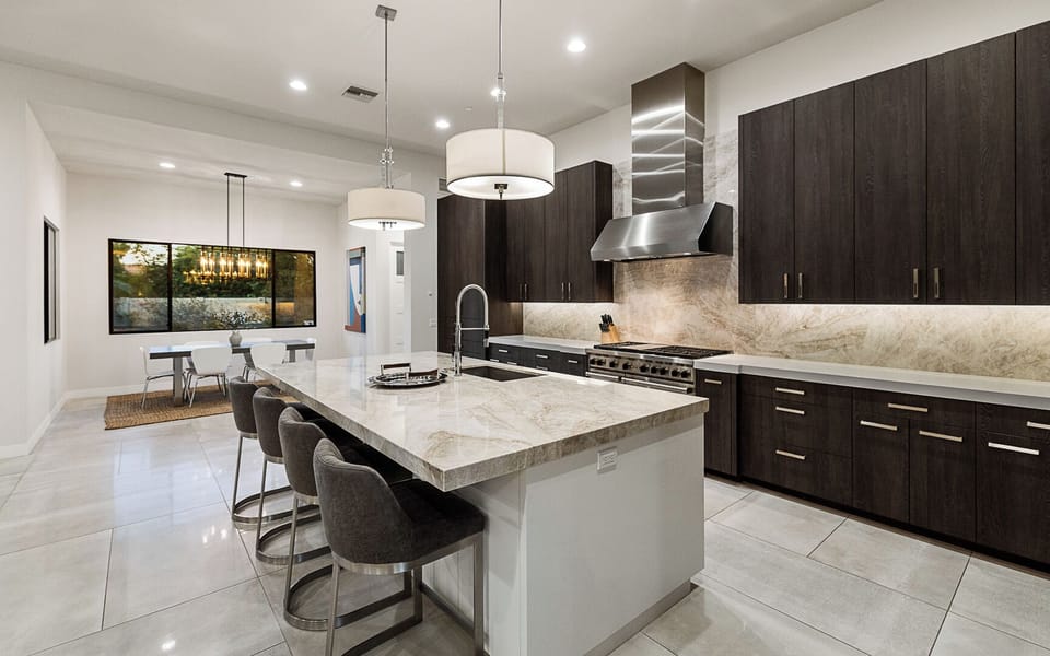 Sleek modern kitchen with spacious island and connected dining area
