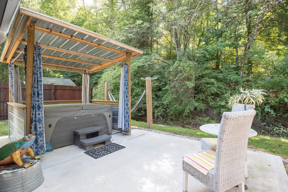 Covered hot tub with draperies offers hot tub frolic in any weather privately