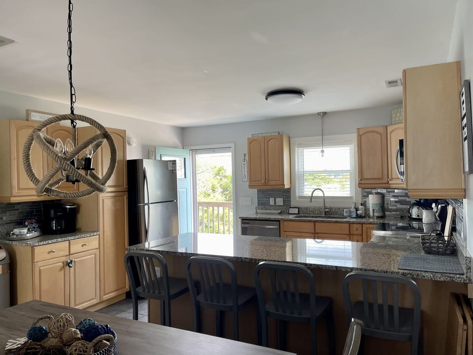 Enough bar seating for four guests, plus table seating for up to 6 guests