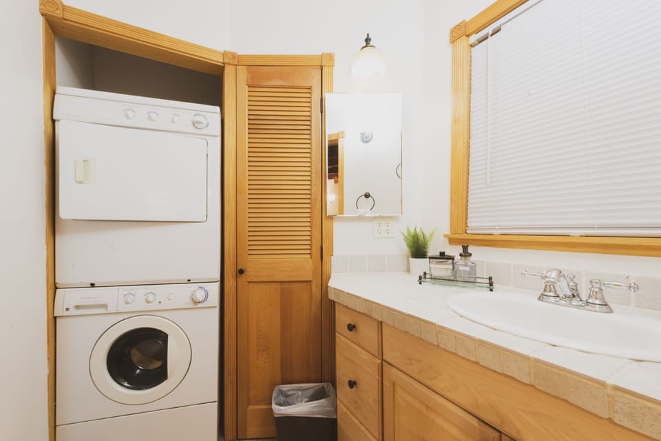 The washer and dryer is tucked in the closet off the bathroom.