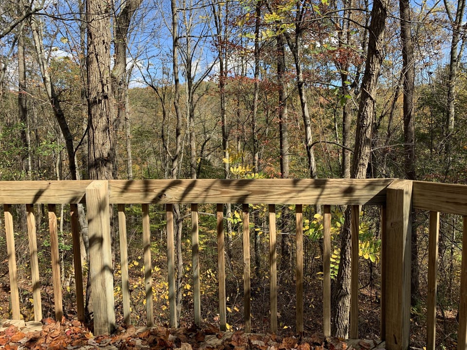 Awesome wrap-around porch overlooking the woods, fire pit and lower deck.