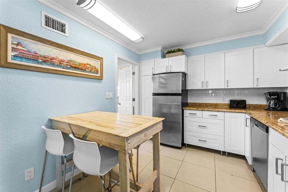 Fully equipped kitchen with granite counters, stainless steel appliances, dishwasher, and a cozy dining nook — everything you need for a home-cooked meal.