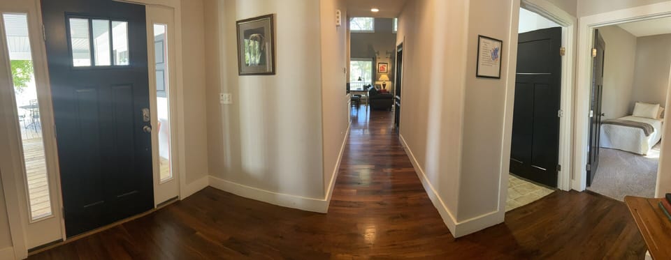 Front door far left, entry hall, laundry, main level guest room far right. 