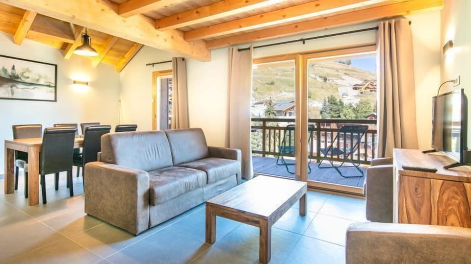 Sink into the cozy sofa and watch a show on TV.