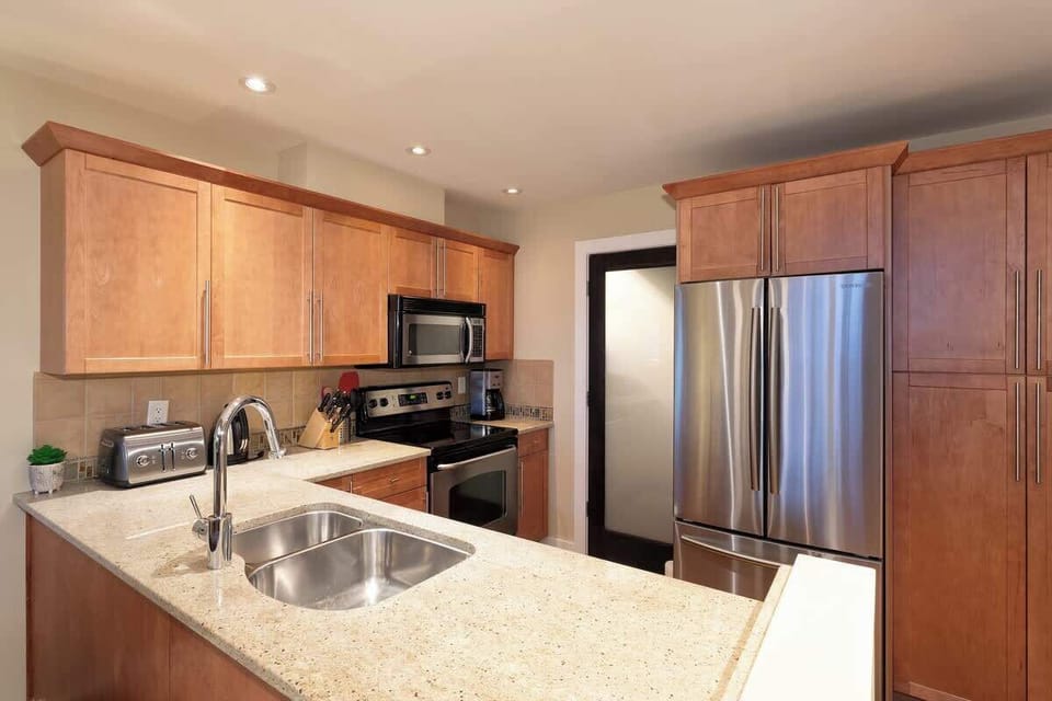 - Stainless steel finishes and modern cabinetry shine  
- Double sink and bright lighting for easy meal prep  
- Fully equipped for cooking after outdoor adventures  
