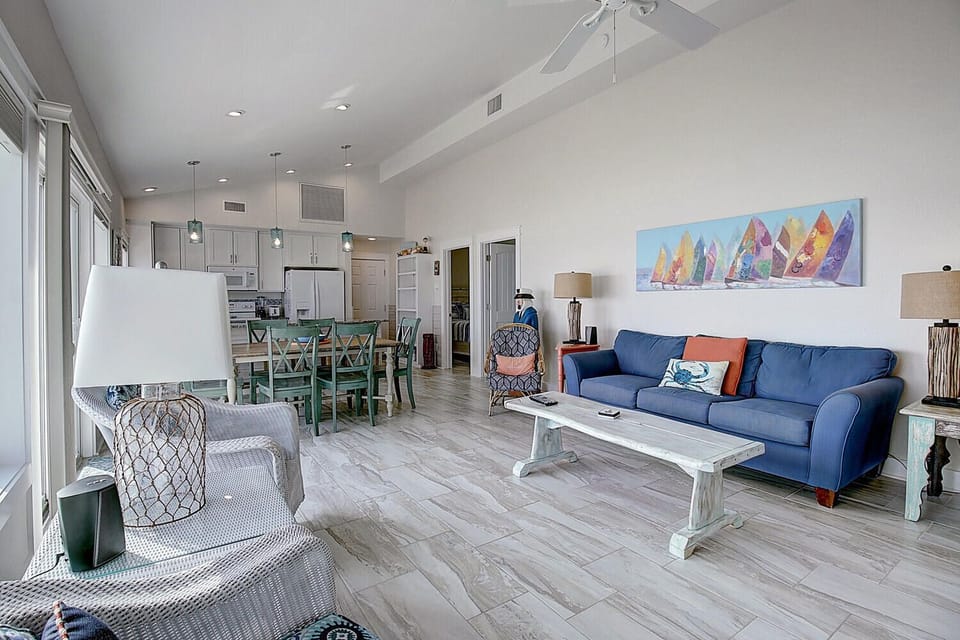 Sink into your coastal retreat with a bright open layout, nautical touches, and that perfect blue sofa for evening relaxation.
