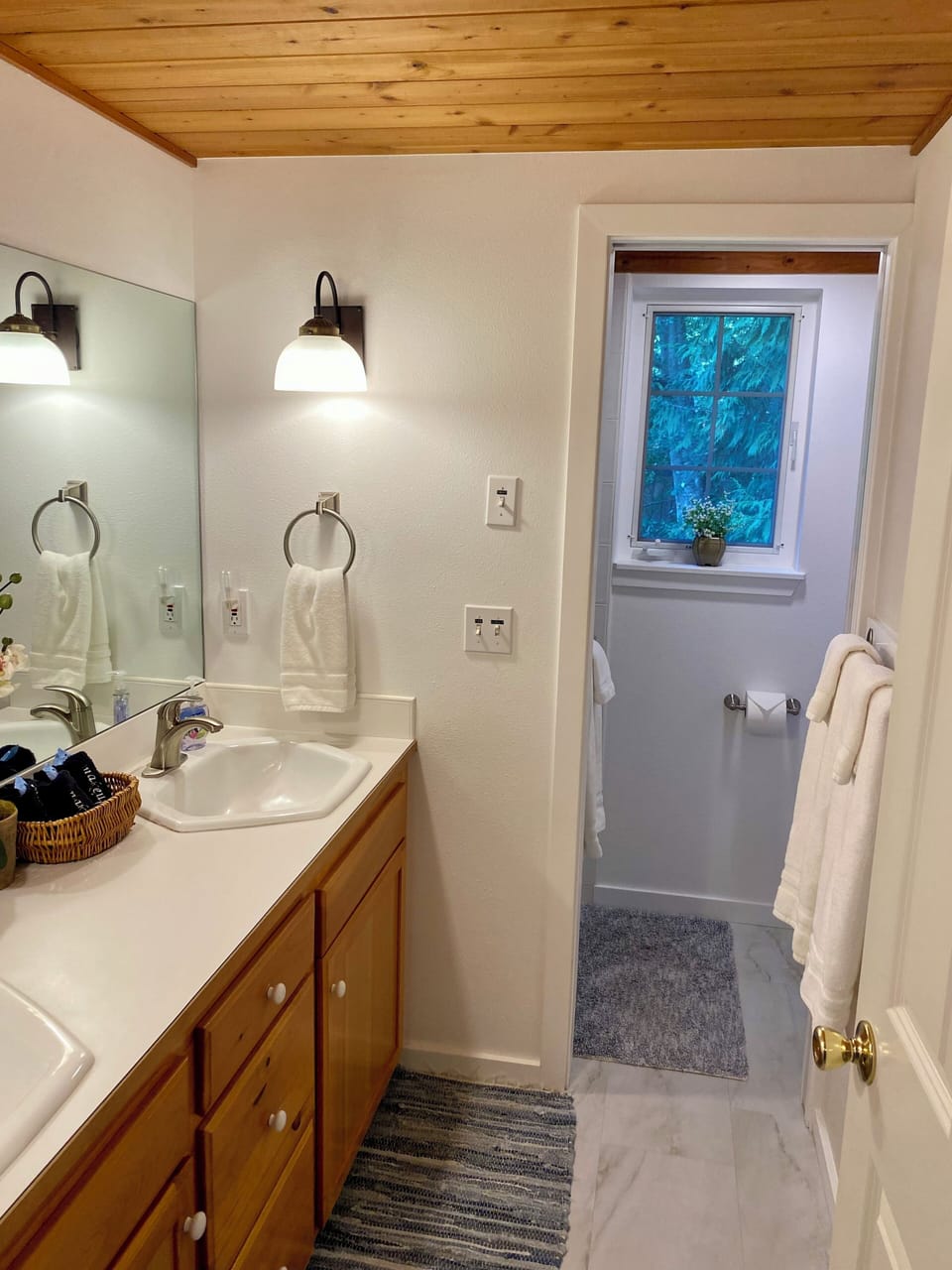 There is a separate shower and toilet beyond the pocket door, for privacy.