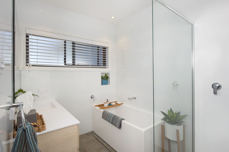 Bath & shower room with guest toiletries and bathroom linens 