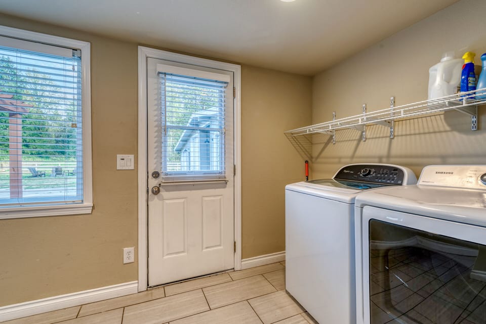 Laundry area with washer and dryer and complimentary detergent