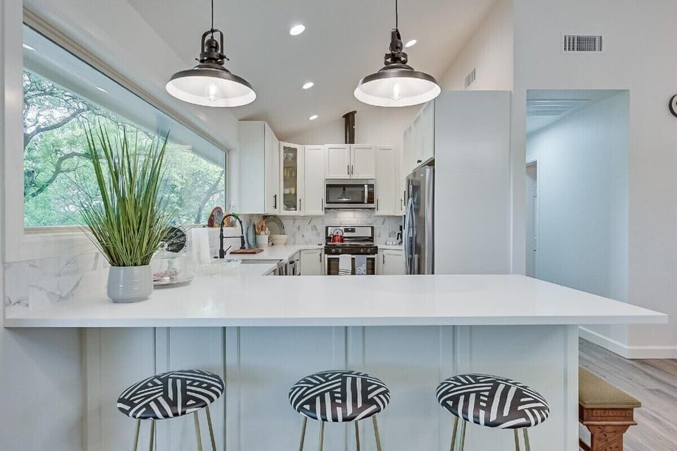 Open kitchen with all new appliances and gas stove.