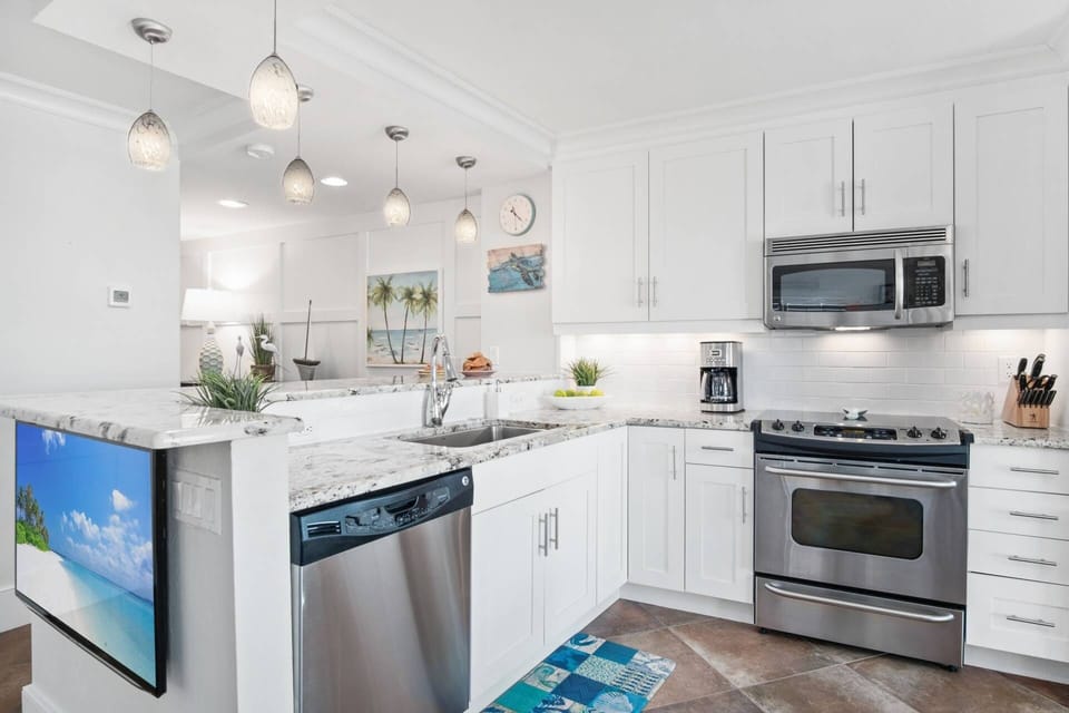 The kitchen features full-size stainless appliances, ample storage and plenty of meal prep area.
