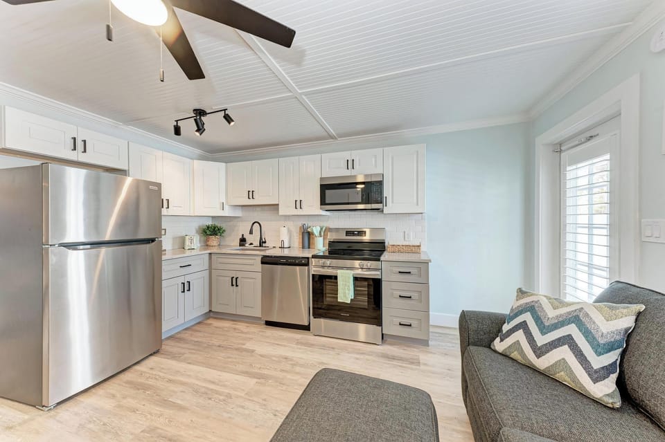 Kitchen with stainless steel appliances open to the dining and living area