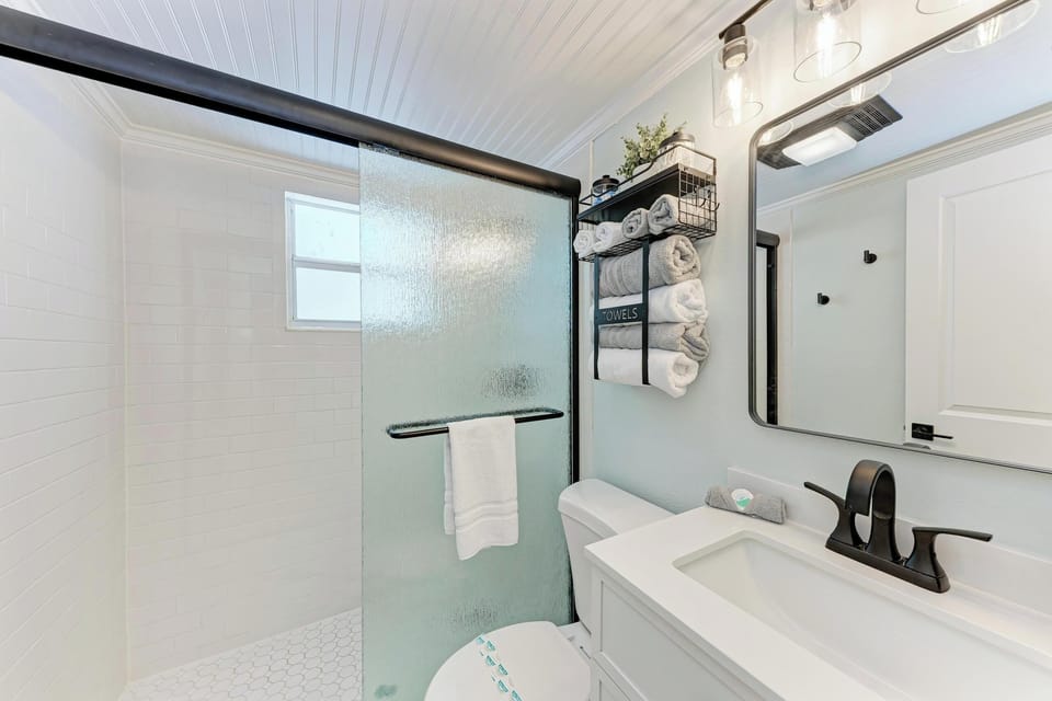 Modern bathroom with walk-in tiled shower and contemporary fixtures