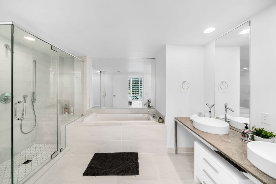 Both jacuzzi and shower in the bathroom