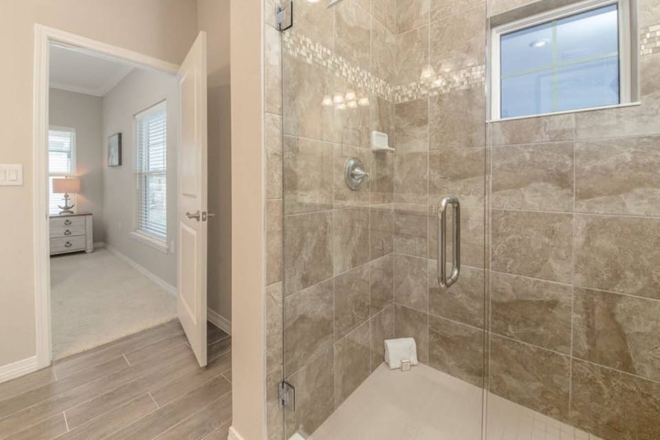 Beautiful tiled walk in shower is part of the Master Bedroom suite