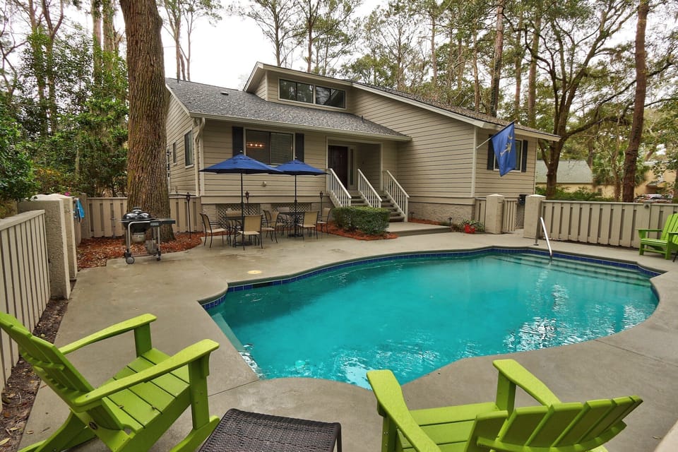 Private pool with outdoor furniture and charcoal Weber grill