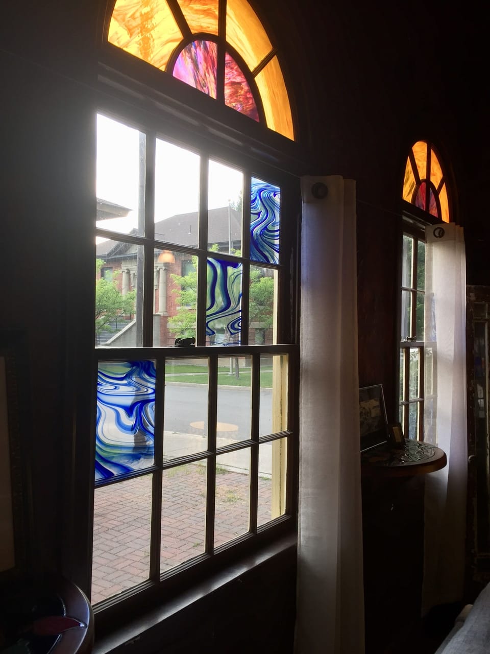 Through stained glass windows you'll see the historic Carnegie library