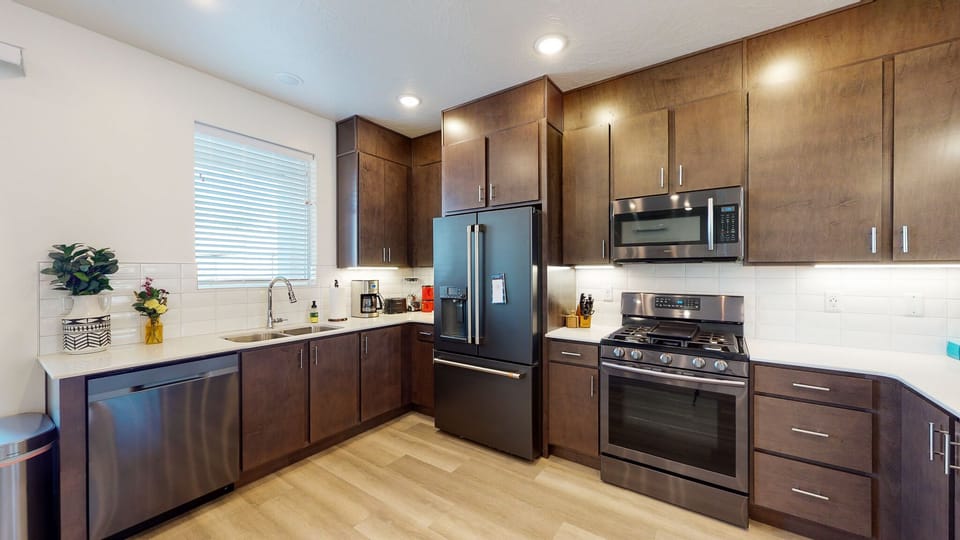 Spacious kitchen with upgraded fridge and full stocked kitchen and coffee bar.