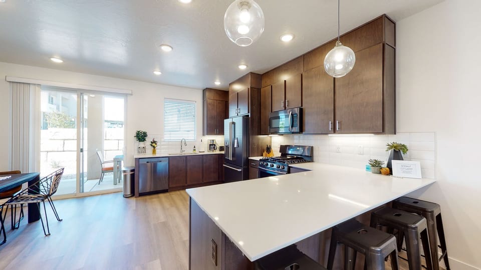 Spacious kitchen with upgraded fridge and full stocked kitchen and coffee bar.