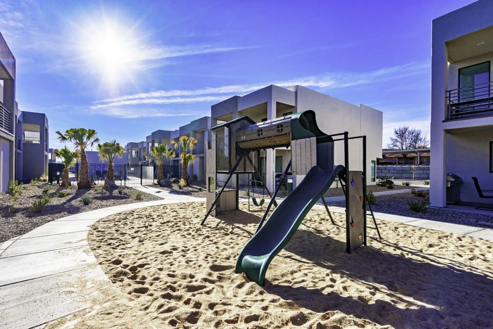 Playground adjacent to the pool and grass area