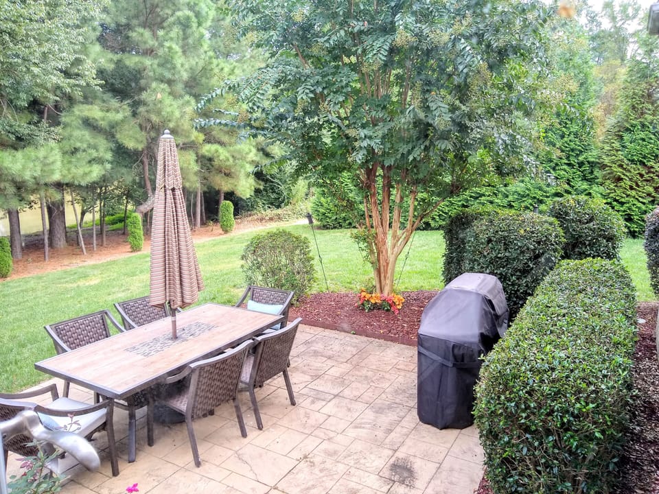 patio with table seating for six and webber bbq