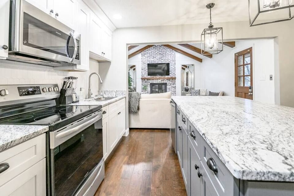 The kitchen features stunning granite countertops, durable, elegant, and perfect for meal prep or morning coffee chats with loved ones.