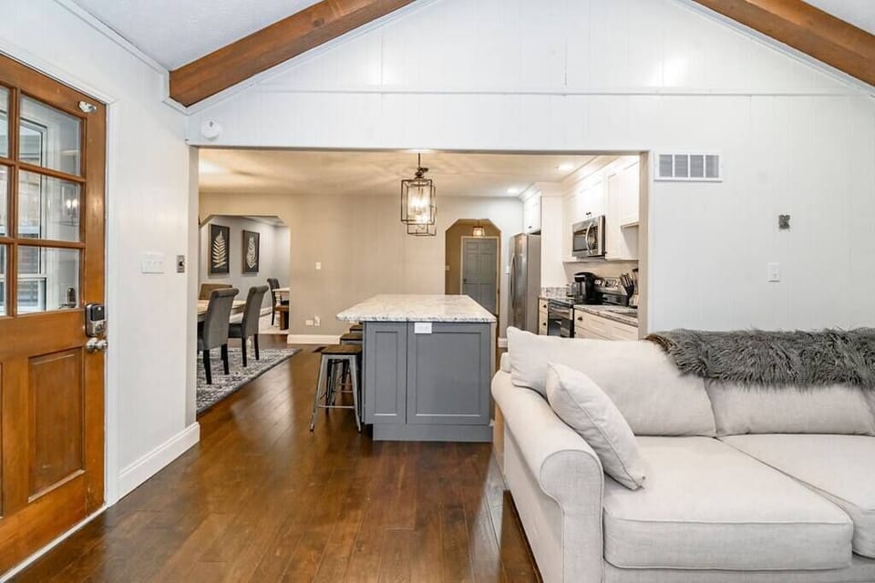 The cozy living room offers the perfect space to unwind, complete with comfortable seating and modern touches for a relaxing retreat.