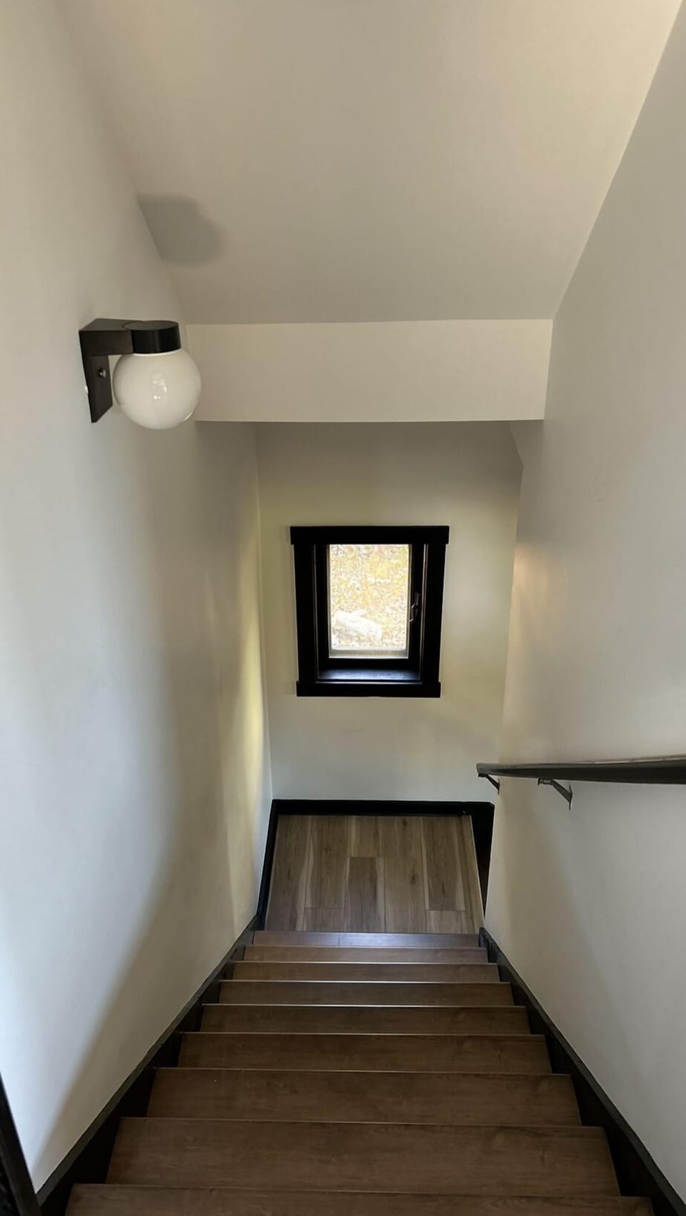 Stairwell to lower level rec room, 3 bedrooms and a full bathroom.