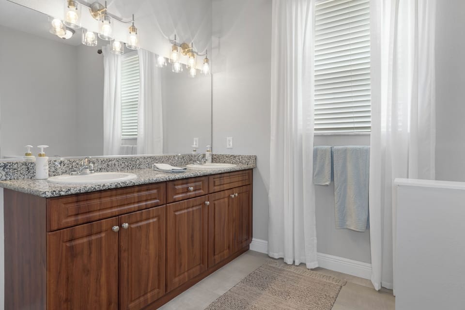 Master bathroom with a huge tub, a separate shower, toilet and two sinks