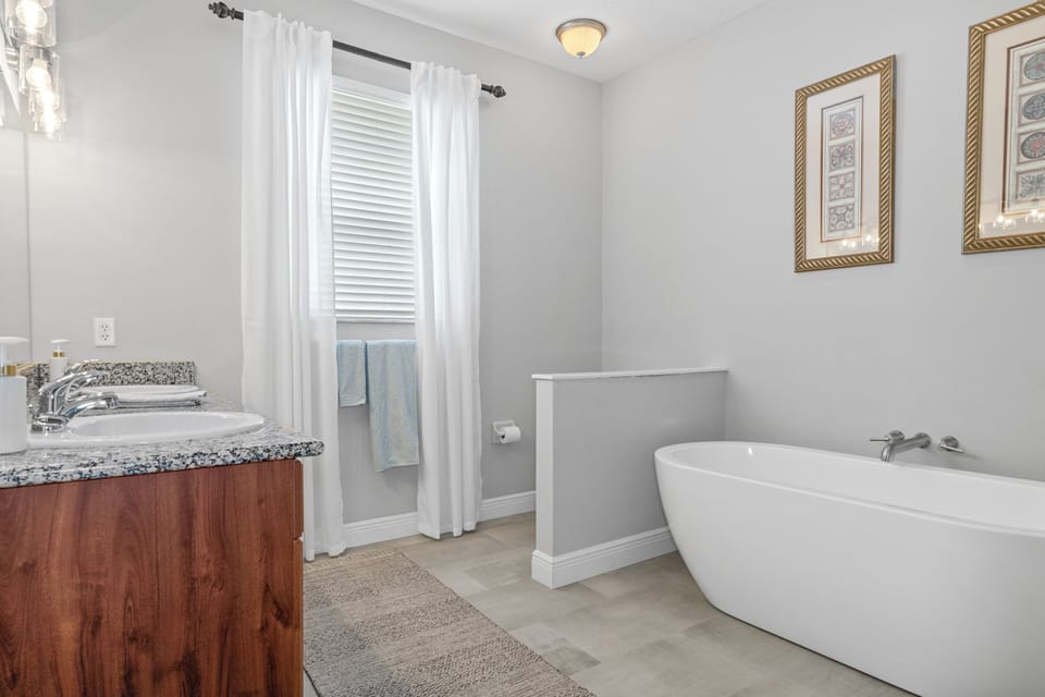 Master bathroom with a huge tub, a separate shower, toilet and two sinks