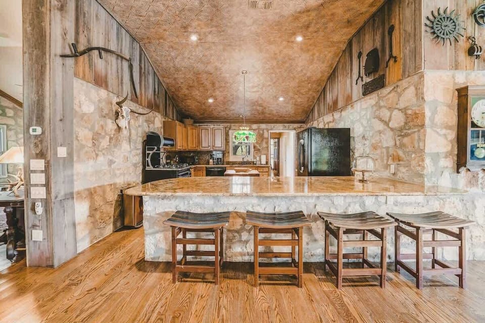 The Ranger modern kitchen blends the vintage inspired stove, granite countertops, dishwasher, and modern conveniences with the original camp stone walls.
