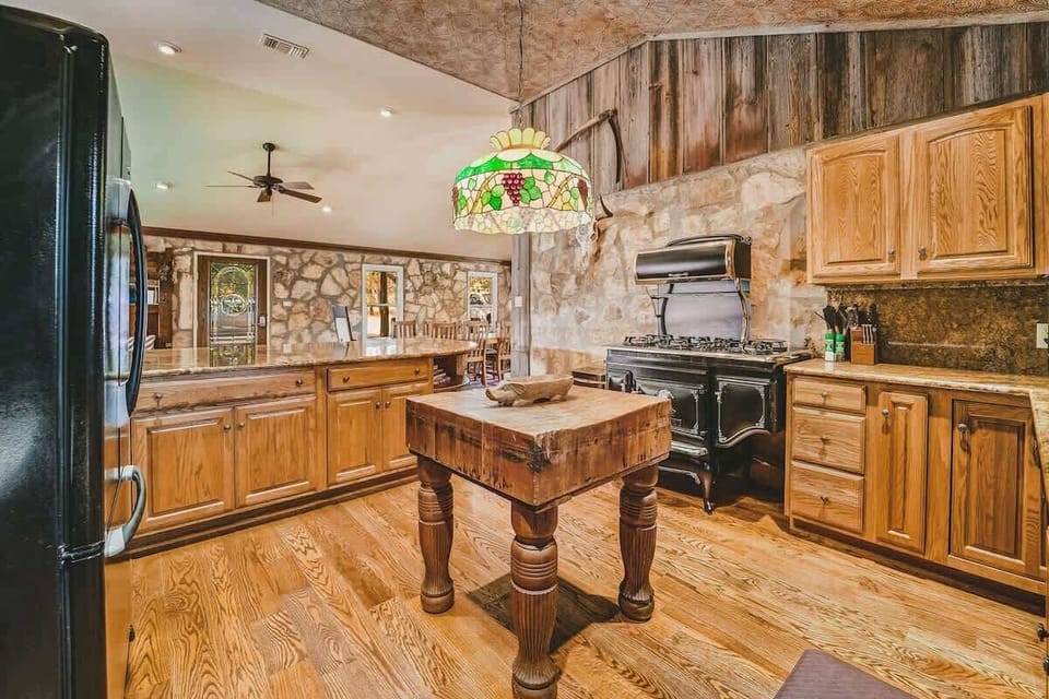 The Ranger modern kitchen blends the vintage inspired stove, granite countertops, dishwasher, and modern conveniences with the original camp stone walls.