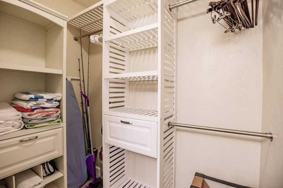 The walk-in closet has ample space for your clothes. Extra towels & bedding are also stored here along with cleaning equipment, iron board, etc.