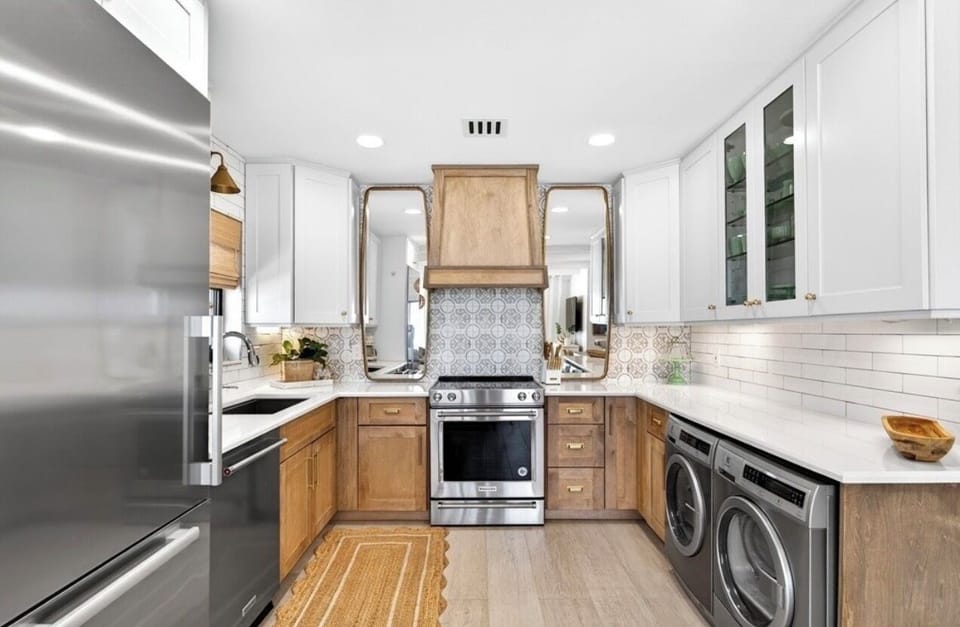 Coastal-chic kitchen with warm wood accents, modern finishes & ocean views.