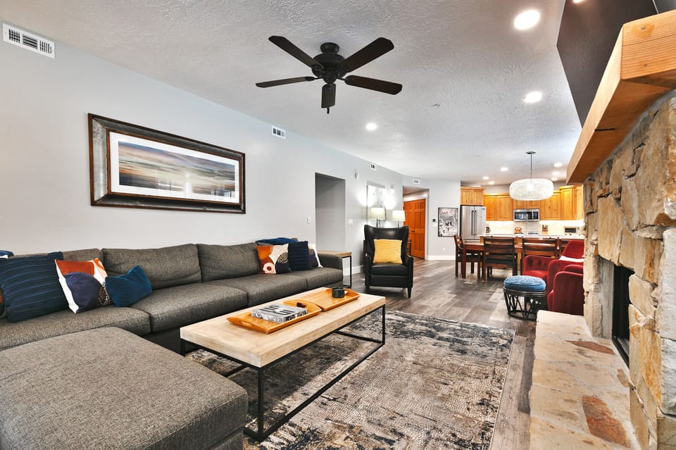 Gray tweed sectional couch in the living room with solid wood coffee table