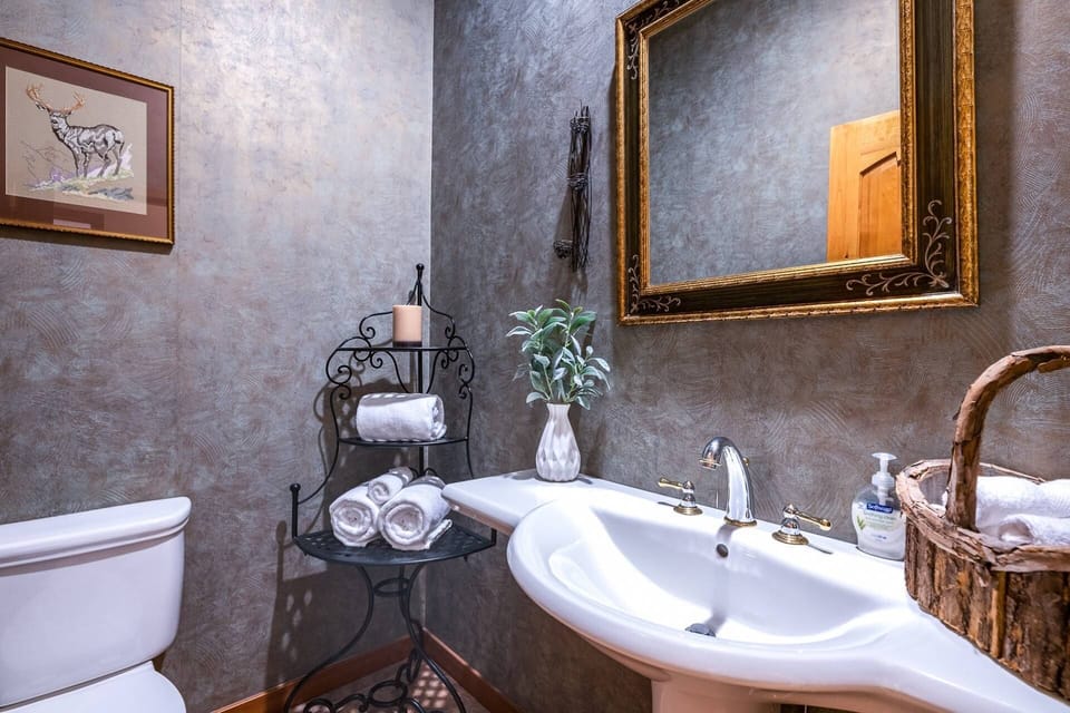 A lovely half bathroom off of the main floor hallway. This is one of 3.5 bathrooms this 4300sf gorgeous Colorado home offers your 12 guests!