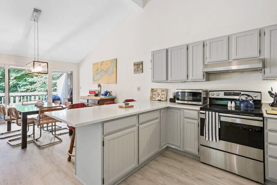 Open concept fully equipped kitchen to dining area.