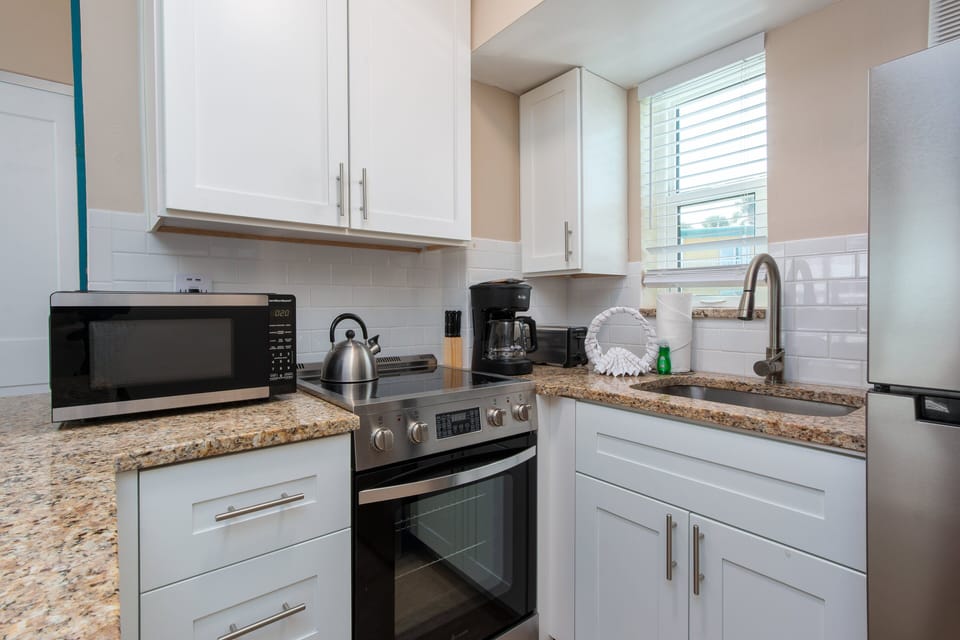 The kitchen is equipped with basics for convenience. It also has a mini breakfast bar to enjoy your meals, or it could double as a work station too!
