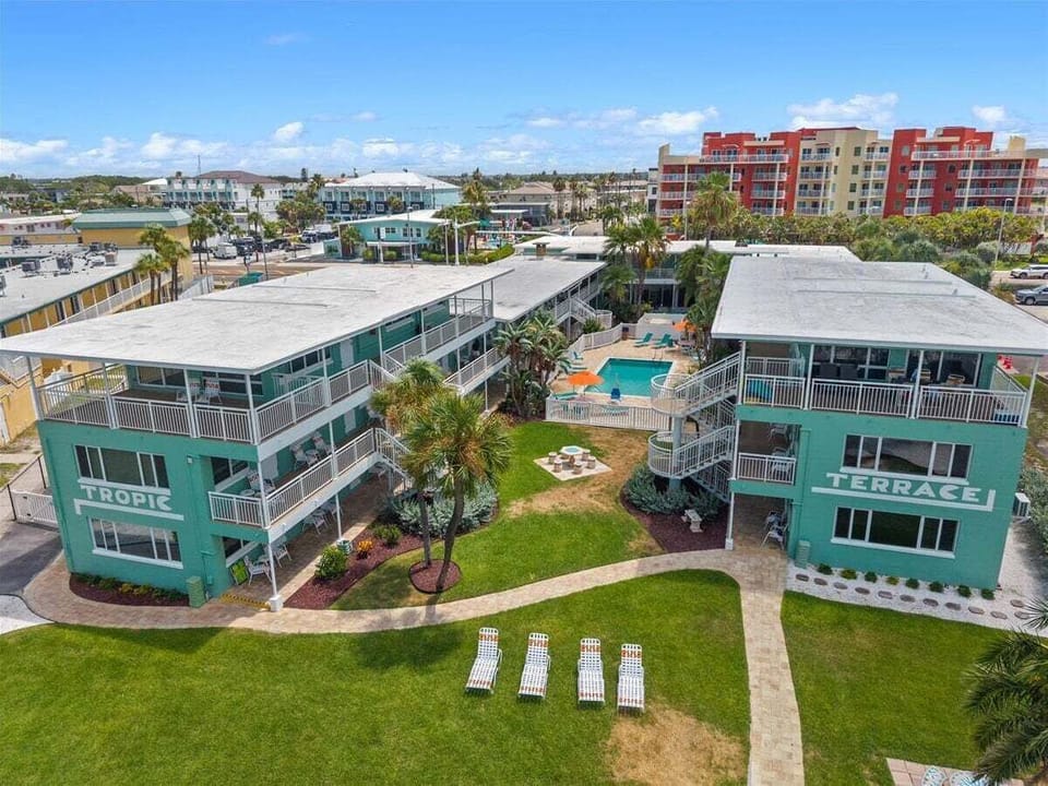 Tropic Terrace sits right on the beach, with a lush pool courtyard tucked between buildings and the Gulf just steps away. Sun, sand, and resort charm all in one place.