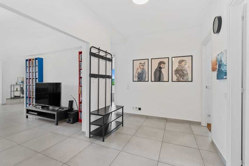 Relax in our spacious living area, adorned with quirky art and ample entertainment options.