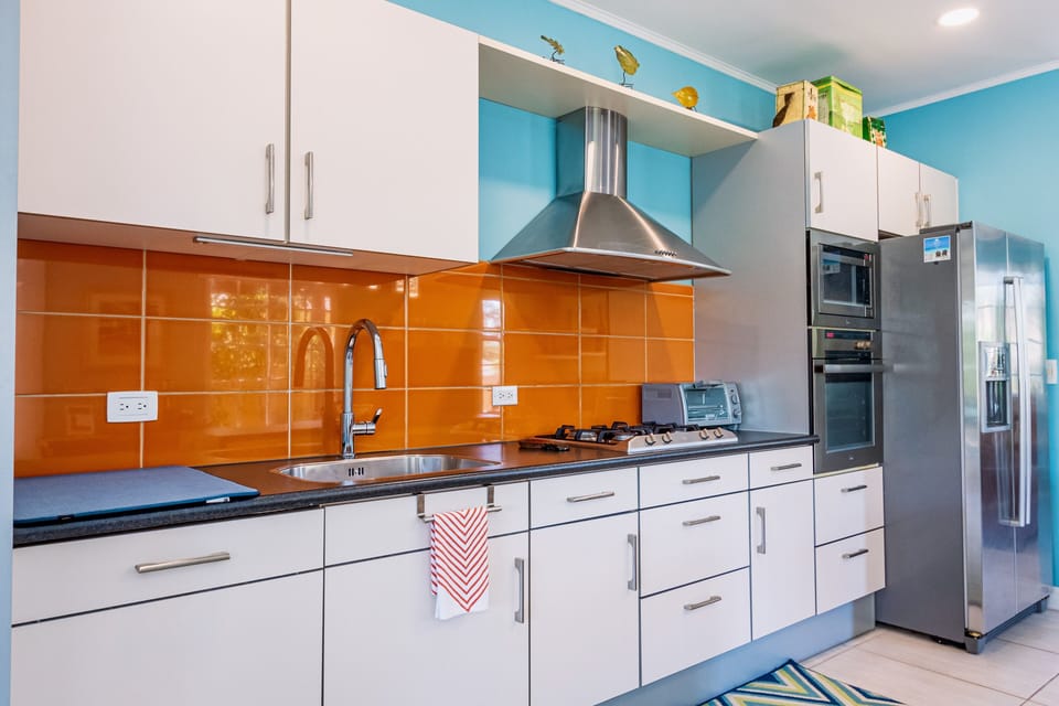 Prepare meals with ease in our fully equipped kitchen featuring sleek stainless-steel appliances, combining functionality with modern style.